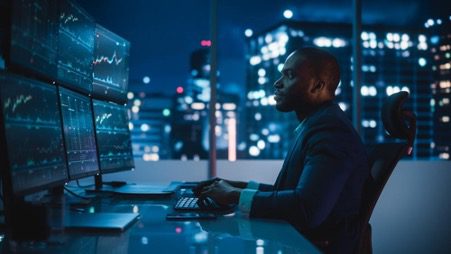 produce_etfs_banner – PU Prime | More Than Trading business man sitting in front of the computer
