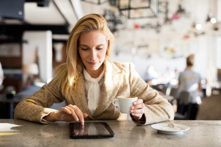 – PU Prime | More Than Trading Woman sitting with coffee